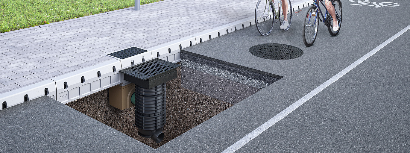 Computergrafik - Runde Schachtabdeckung und Querschnitt eines Straßenablaufs auf einem Radweg