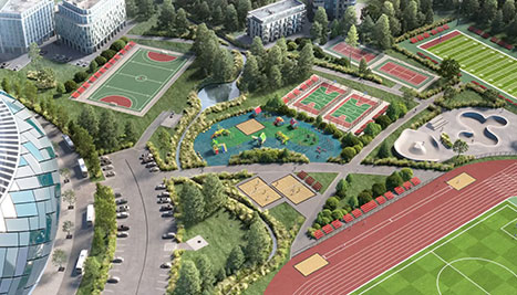 Sportkomplex mit Fußballstadion, Tennis- und Volleyballplätzen, Laufbahn und Spielplatz, umgeben von Grünflächen und Parkplätzen.